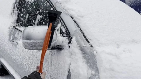 Cleaning snow off a car Stock Footage 229966292