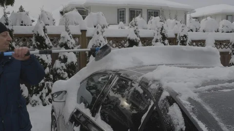Cleaning snow off a car (medium shot). Stock Footage 123127301