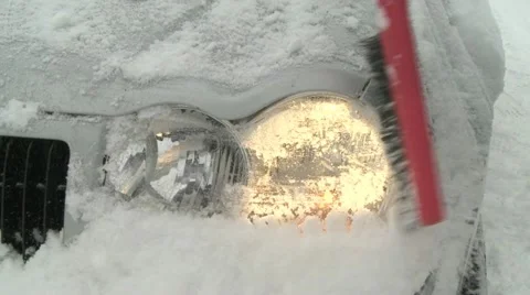 Cleaning snow off headlight Stock Footage