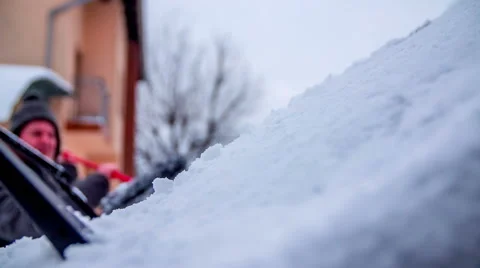 Cleaning the snow off the windshield on a car Stock Footage 59224231