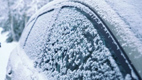 Cleaning snowy car side windows with brush Stock Footage 102955990