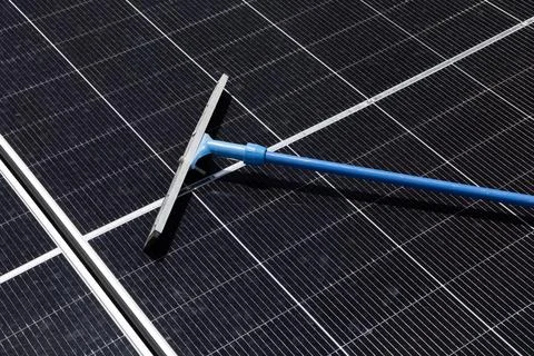 Cleaning Solar Panel concept, Sweeper dirty dust for power efficiency at so.. Stock Photos