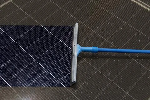 Cleaning Solar Panel concept, Sweeper dirty dust for power efficiency at so.. Stock Photos