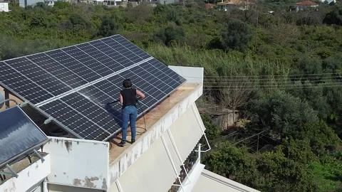 Cleaning Solar Panels on Rooftop Stock Footage 345669017