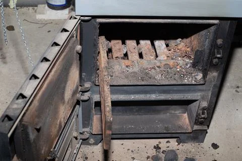 Cleaning the solid fuel boiler from the remains of firewood and coal. Boiler  Фото