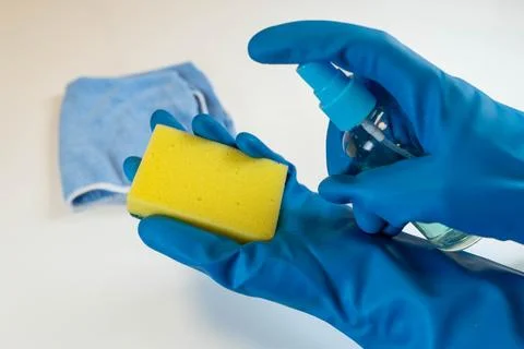 Cleaning solution being applied to a yellow dish sponge, showcasing eco-frien Stock Photos