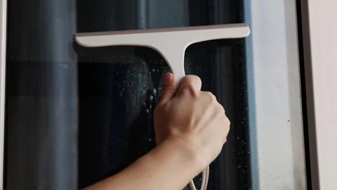 A cleaning specialist or hostess thoroughly cleans the windows Stock Footage 305925429