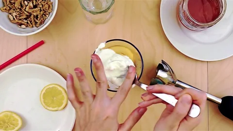 Cleaning spoon from cheese while making a healthy and nutritious smoothie Stock Footage 73886758