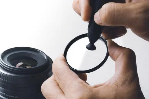 Cleaning stain on UV filter of camera lens with carbon brush clean Stock Photos