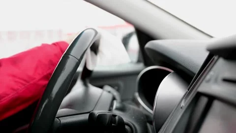 Cleaning steering wheel of a car using wet wipe from bacteria and virus. Stock-Footage 336266340