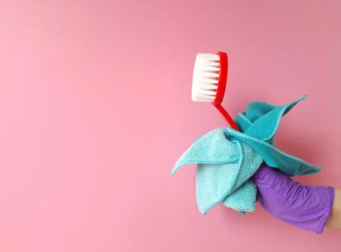 Cleaning supplies in hand Stock Photos