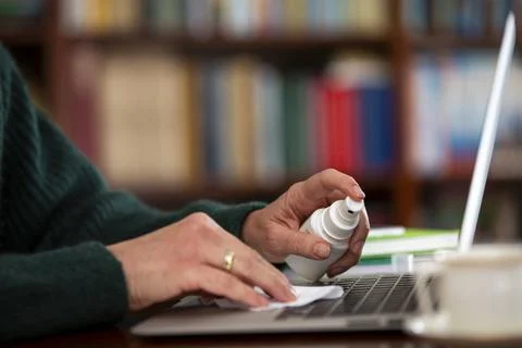 Cleaning the surface of the computer keyboard. Stock Photos