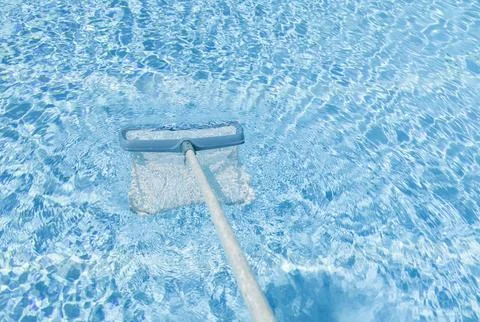 Cleaning surface of pool with scoop net Stock Photos