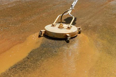 Cleaning sweeper machine washes asphalt road with a water spray Stock Photos