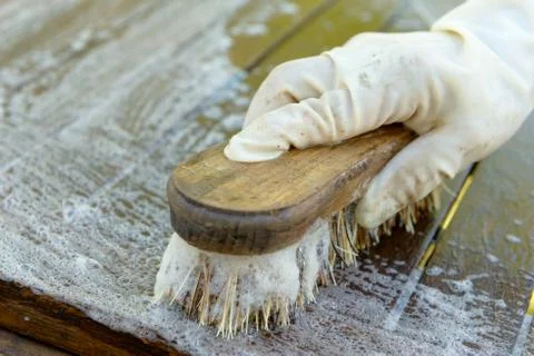 Cleaning a table with a hard brush Stock Photos