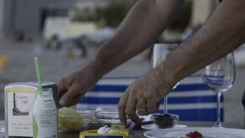 Cleaning a Table by the Sea Stock Footage 82845742