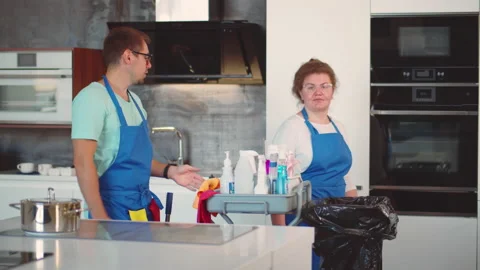 Cleaning team with cart work in modern kitchen. Realtime Stock Footage 225532934