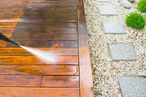 Cleaning terrace with a power washer - high water pressure cleaner on terrace Stock Photos