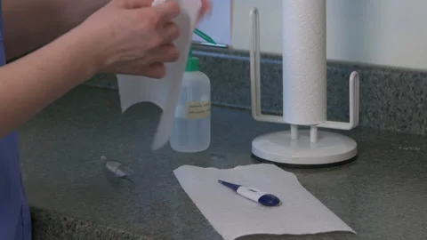 Cleaning thermometer with alcohol Stock-Footage 142535910