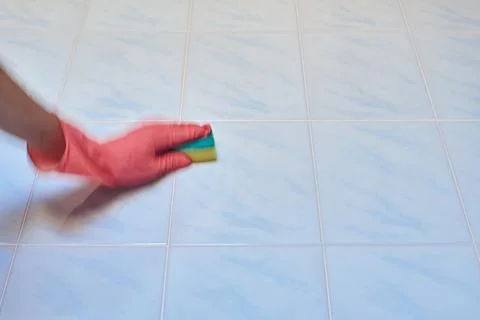 Cleaning a tile in the bathroom Stock Photos