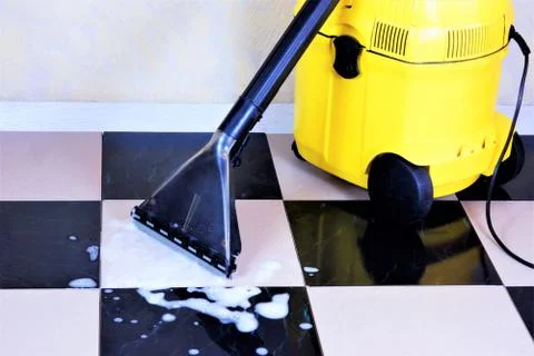 Cleaning tile floor surface foam with a wet vacuum, sanitary restoring clean Stock Photos