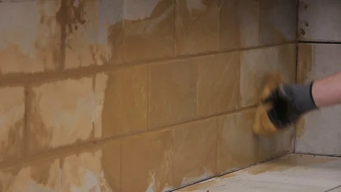 Cleaning tiles after grouting Stock Footage 111866043