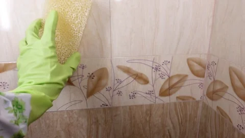 Cleaning tiles in a bathroom with a sponge Stock Footage 342213352