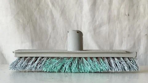 Cleaning tool with soft bristles on a plain background in a work environment Stock Photos