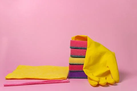 Cleaning tools on a pink background. Indoor cleaning tools. Stock Photos