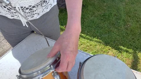 Cleaning a Traditional Pair of Hand Drums with Compressed Air Stock Footage 342016572