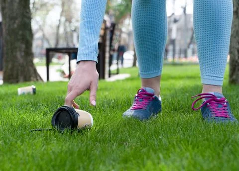 Cleaning up trash in the park while jogging Stock Photos