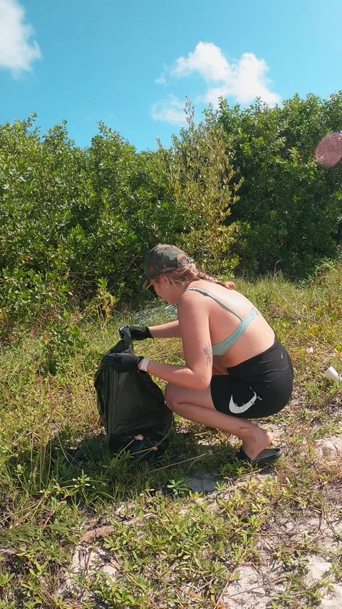 Cleaning trash from public beach in Mexico. Contributing to better world Stock Footage 233436388
