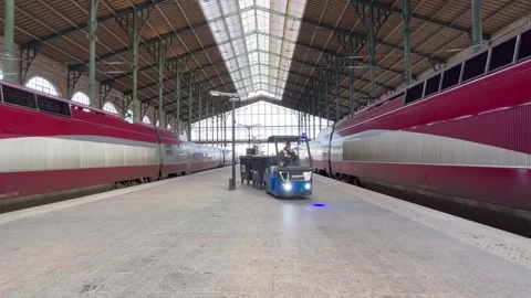 Cleaning Vehicle Driving Between Two Eurostar Trains On Gare Du Nord Platform Stock Footage 335373002
