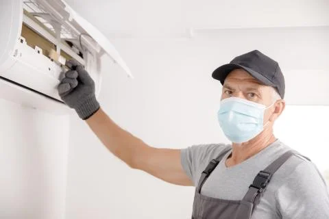 Cleaning ventilation service, worker fixes problem. Dirty and dusty air Stock Photos