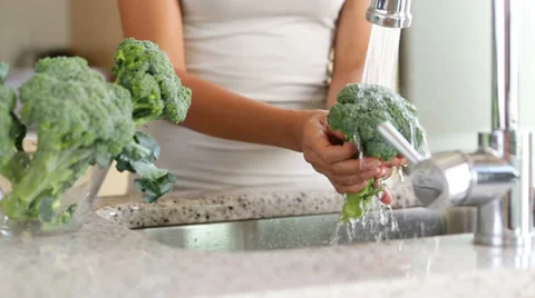 Cleaning washing broccoli vegetables in kitchen Video stock 35224554