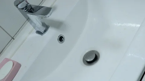 Cleaning the washstand in the bathroom Stock Footage 128606027