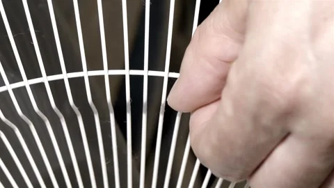 Cleaning White Fan Grille in Close Up Against a Dark Background Stock Footage 343351041