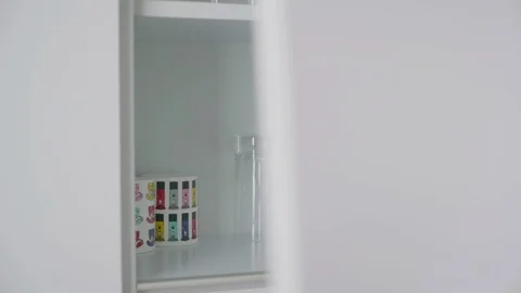 Cleaning white kitchen cabinet filled with water glasses. Video stock 91030432