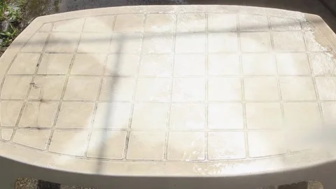 Cleaning a white plastic garden table with a high pressure water gun 스톡 동영상 149763417