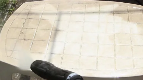 Cleaning a white plastic garden table with a high pressure water gun 스톡 동영상 149763431