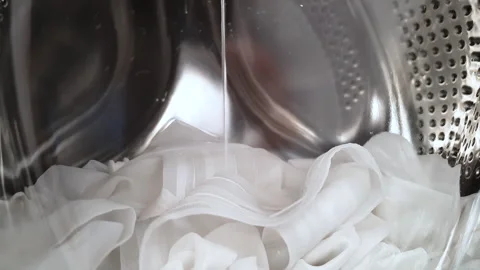 Cleaning white silk curtains Stock Footage 241888945