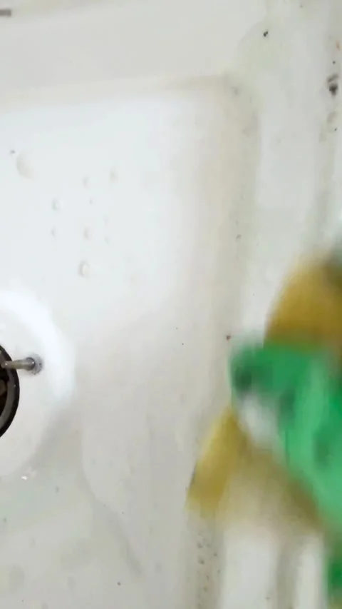 Cleaning a white sink surface with sponge and soap Video stock 331977143