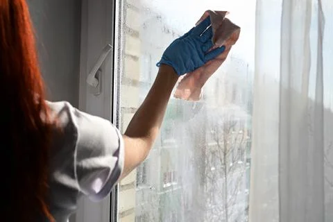 Cleaning window pane with detergent, spring cleaning concept Stock Photos