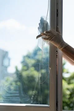 Cleaning a window Stock Photos