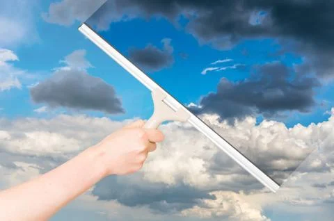 Cleaning window with rubber squeegee and cleaning the sky Stock Photos