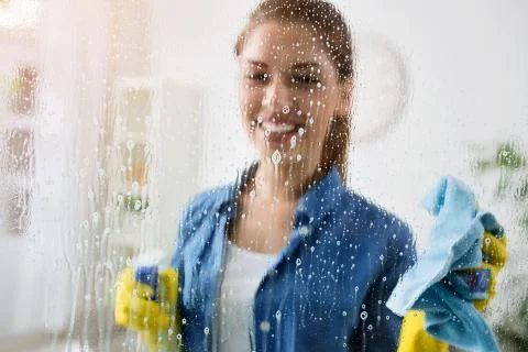 Cleaning window with special cleaner Stock Photos