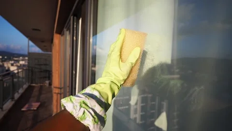 Cleaning windows on a balcony with a sponge Stock Footage 340244488