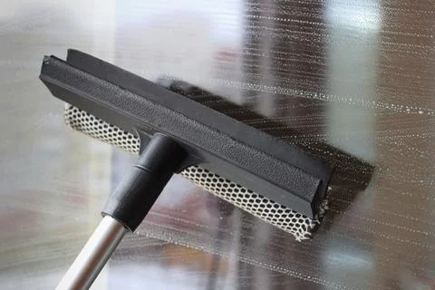 Cleaning windows during spring cleanup routine Stock Photos