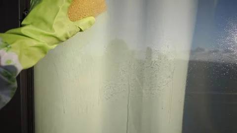 Cleaning windows with a sponge in the morning light Stock Footage 341907685