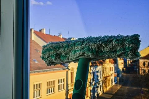 Cleaning windows with a squeegee. Cleaning concept. Washing window, close up Fotos de archivo